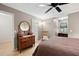 Cozy bedroom featuring a wooden dresser, ceiling fan, and a bright window, creating a warm and inviting space at 1560 Bubbling Creek Ne Rd, Atlanta, GA 30319