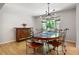 Dining room with wood floors, modern lighting and table with seating for six at 1560 Bubbling Creek Ne Rd, Atlanta, GA 30319
