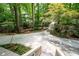 Spacious driveway leading to a home nestled amongst mature trees, offering privacy and scenic views at 1560 Bubbling Creek Ne Rd, Atlanta, GA 30319