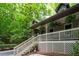 Inviting covered front porch with white railing, steps, and hanging plants creates a welcoming entryway at 1560 Bubbling Creek Ne Rd, Atlanta, GA 30319