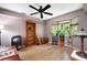 Inviting living room area with hardwood floors, a decorative bookcase, and abundant sunlight from nearby windows at 1560 Bubbling Creek Ne Rd, Atlanta, GA 30319