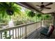 Relaxing covered porch with hanging ferns, offering a serene outdoor space with views of the lush surroundings at 1560 Bubbling Creek Ne Rd, Atlanta, GA 30319