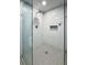 Close up of a beautifully tiled shower with pebble flooring and a glass partition at 1560 Bubbling Creek Ne Rd, Atlanta, GA 30319