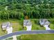 Aerial view of home showcasing its landscaping, front-facing garage, driveway, manicured lawn, and neighboring houses at 17 Ridgeline Nw Way, Cartersville, GA 30121