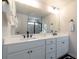 Bathroom showcasing a double vanity with white countertops, matte black fixtures, and a large mirror at 17 Ridgeline Nw Way, Cartersville, GA 30121