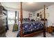 Bedroom showcasing a striking four-poster bed with a floral pattern, complemented by eclectic decor and furnishings at 17 Ridgeline Nw Way, Cartersville, GA 30121