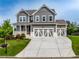 Charming two-story home featuring a gray facade, white trim, a well-manicured lawn, and a driveway at 17 Ridgeline Nw Way, Cartersville, GA 30121