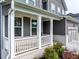 Charming covered porch with white pillars, complemented by the home's gray exterior and manicured landscaping at 17 Ridgeline Nw Way, Cartersville, GA 30121