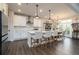 A gourmet kitchen with white cabinets, island with barstool seating, and modern stainless steel appliances at 17 Ridgeline Nw Way, Cartersville, GA 30121