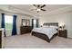Spacious main bedroom with tray ceiling, featuring large windows, plush carpet, and dark wood furniture at 17 Ridgeline Nw Way, Cartersville, GA 30121
