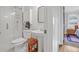 Bathroom with glass shower, pedestal sink, and view into the bedroom at 233 Dorris Sw Dr, Marietta, GA 30060