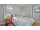 Bright bedroom featuring two windows with white curtains and geometric patterned bedspread at 233 Dorris Sw Dr, Marietta, GA 30060