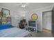 Bedroom with a ceiling fan, desk with computer, and shelving unit filled with books at 233 Dorris Sw Dr, Marietta, GA 30060