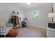 Bedroom with window, ceiling fan, desk, and comfortable plaid chair at 233 Dorris Sw Dr, Marietta, GA 30060