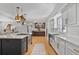 Open concept kitchen with central island, white cabinets, subway tile backsplash, and stainless steel appliances at 233 Dorris Sw Dr, Marietta, GA 30060