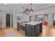 Kitchen island features a built-in stovetop and a hanging rack with copper colored pots at 233 Dorris Sw Dr, Marietta, GA 30060