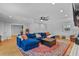 Open-concept living room with a blue sofa, hardwood floors, and a cozy brick fireplace, perfect for entertaining at 233 Dorris Sw Dr, Marietta, GA 30060