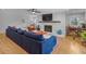 Spacious living room featuring hardwood floors, a white painted brick fireplace, and stylish decor at 233 Dorris Sw Dr, Marietta, GA 30060