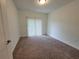 Cozy bedroom featuring plush carpeting, a large window with blinds, and neutral decor at 525 Parkway Dr Ne # 305, Atlanta, GA 30308
