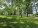Apartment building surrounded by mature trees and green lawn offering a serene and park-like setting at 525 Parkway Dr Ne # 305, Atlanta, GA 30308