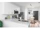 Contemporary kitchen boasting white cabinets, stainless steel appliances, and stylish marble countertops at 525 Parkway Dr Ne # 305, Atlanta, GA 30308