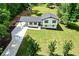 Aerial view of a well-maintained home featuring a long driveway and an expansive green lawn at 550 Oglesby Bridge Se Rd, Conyers, GA 30094