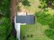 Aerial perspective of home showing back patio, driveway, and large manicured lot with green grass at 550 Oglesby Bridge Se Rd, Conyers, GA 30094