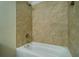 This bathroom features neutral tile and a new tub with shower at 550 Oglesby Bridge Se Rd, Conyers, GA 30094
