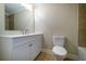 Bathroom featuring a new toilet, vanity, tiled shower and floors, and bright light at 550 Oglesby Bridge Se Rd, Conyers, GA 30094