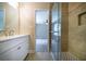 Bathroom featuring a white vanity, large mirror, and a glass shower with decorative tiles at 550 Oglesby Bridge Se Rd, Conyers, GA 30094