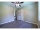 Bedroom featuring hardwood floors, a ceiling fan, and a double-door closet at 550 Oglesby Bridge Se Rd, Conyers, GA 30094