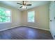 This bedroom features two bright windows, ceiling fan, neutral walls, and hard surface floors at 550 Oglesby Bridge Se Rd, Conyers, GA 30094