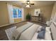 This room features two windows, a ceiling fan, hard surface floors and modern decor at 550 Oglesby Bridge Se Rd, Conyers, GA 30094