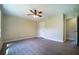 Spacious bedroom featuring a ceiling fan, wood floors, and large door at 550 Oglesby Bridge Se Rd, Conyers, GA 30094