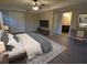 Bedroom with a view into the bathroom, gray floors, neutral walls, ceiling fan, and natural light at 550 Oglesby Bridge Se Rd, Conyers, GA 30094