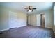 This is a spacious bedroom with two doors, a ceiling fan, and hard surface floors at 550 Oglesby Bridge Se Rd, Conyers, GA 30094