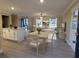 Open-concept dining and living room area with great natural light and hardwood flooring at 550 Oglesby Bridge Se Rd, Conyers, GA 30094