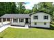 Charming renovated two-story home with a convenient carport and a freshly painted white brick facade at 550 Oglesby Bridge Se Rd, Conyers, GA 30094