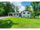 Charming two-story home with a well-maintained lawn, carport, and classic curb appeal at 550 Oglesby Bridge Se Rd, Conyers, GA 30094
