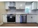Stylish kitchen featuring stainless steel appliances, sleek cabinets, and solid surface counters at 550 Oglesby Bridge Se Rd, Conyers, GA 30094