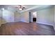 Spacious room with new wood-look floors, neutral paint, and a view into another room at 550 Oglesby Bridge Se Rd, Conyers, GA 30094