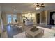 Staged living room and open floor plan to kitchen provides ample space for living and dining at 550 Oglesby Bridge Se Rd, Conyers, GA 30094