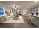 Spacious open-concept living room with stone counters, great natural light, and hardwood floors at 550 Oglesby Bridge Se Rd, Conyers, GA 30094