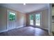 Bright living room featuring hardwood floors and double doors that lead to the deck at 550 Oglesby Bridge Se Rd, Conyers, GA 30094