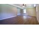 Large room with new gray wood-look floors, neutral paint, ceiling fan, and plenty of light at 550 Oglesby Bridge Se Rd, Conyers, GA 30094