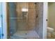 Walk-in shower featuring stone-look tile and a glass enclosure, complete with a shower seat at 550 Oglesby Bridge Se Rd, Conyers, GA 30094
