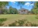 Expansive backyard featuring a modern two-story home with black roof and a well-manicured lawn at 1461 Leach Dr, Lawrenceville, GA 30045