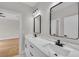 Dual vanity bathroom with marble countertops, modern black fixtures, and sleek mirrors at 1461 Leach Dr, Lawrenceville, GA 30045