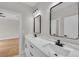 Bathroom featuring double sinks, marble counters, black hardware, and two black framed mirrors at 1461 Leach Dr, Lawrenceville, GA 30045