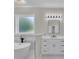 Modern bathroom featuring a soaking tub, white vanity, and sleek fixtures at 1461 Leach Dr, Lawrenceville, GA 30045